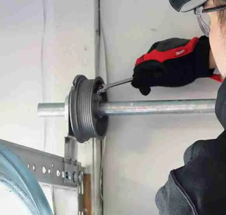 Technician performing garage door cable repair on a residential garage in Dublin, ensuring smooth and safe door operation.