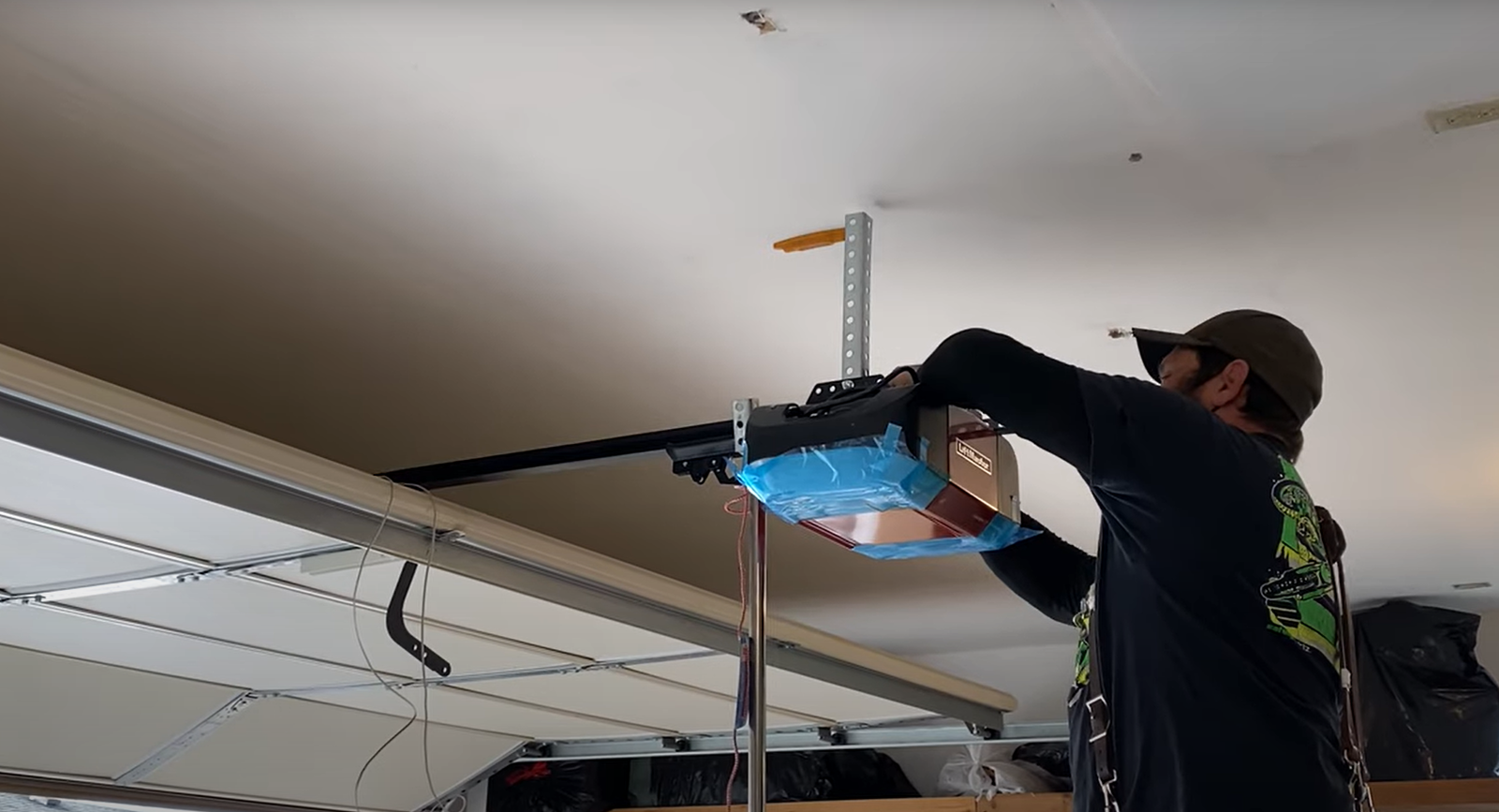 Technician repairing a garage door opener mechanism in a residential garage in Dublin, showcasing professional garage door opener repair services.