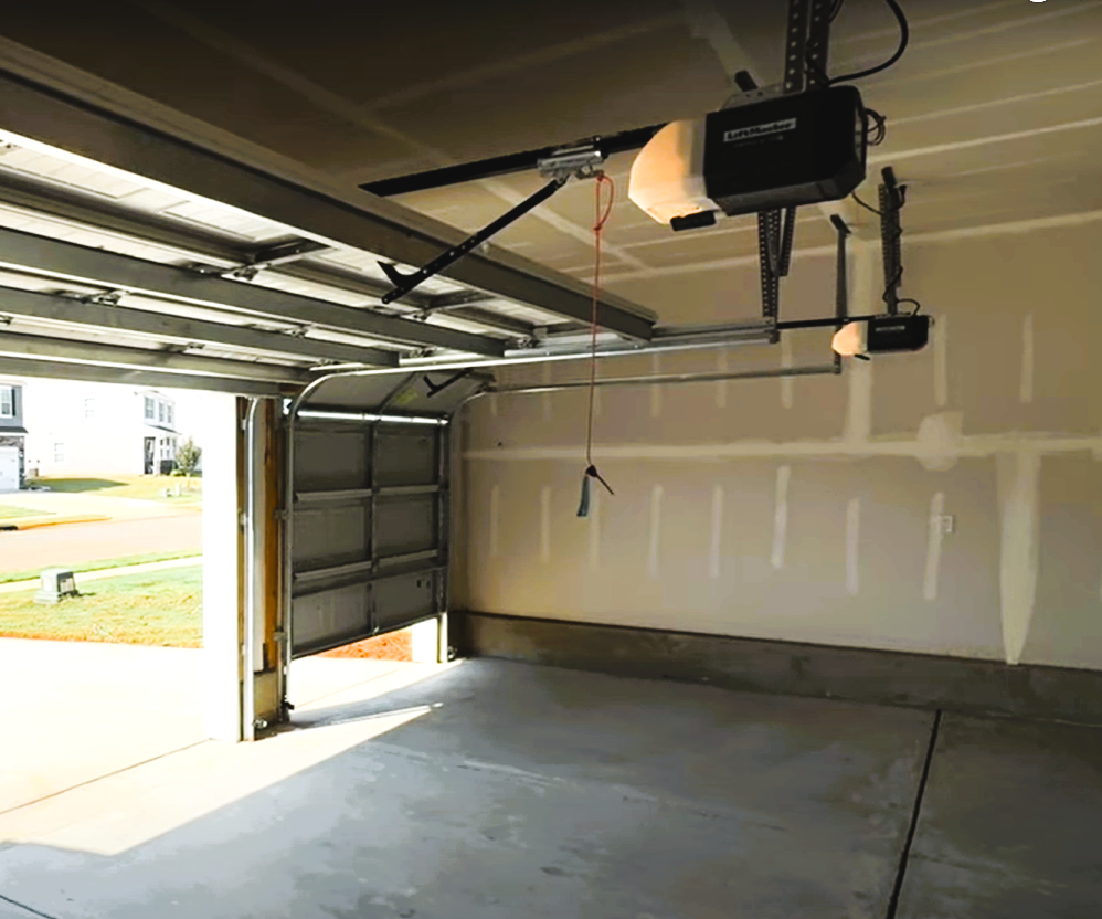 A technician repairing an overhead garage door with professional tools, showcasing Dublin Garage Door Repair services.