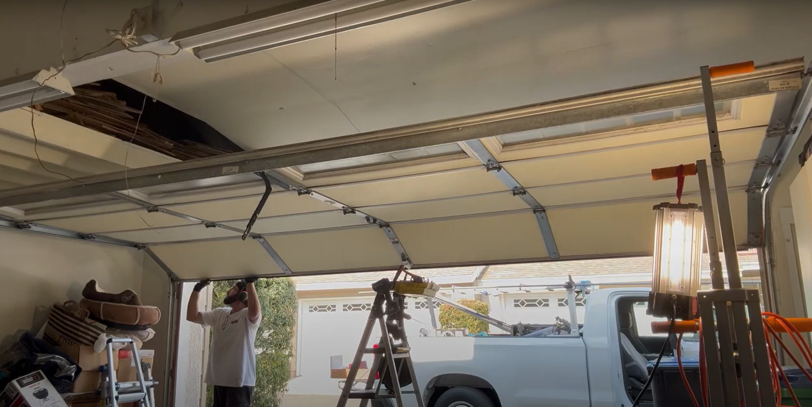 Technician providing same-day garage door repair services in Dublin, adjusting the springs of a residential garage door.