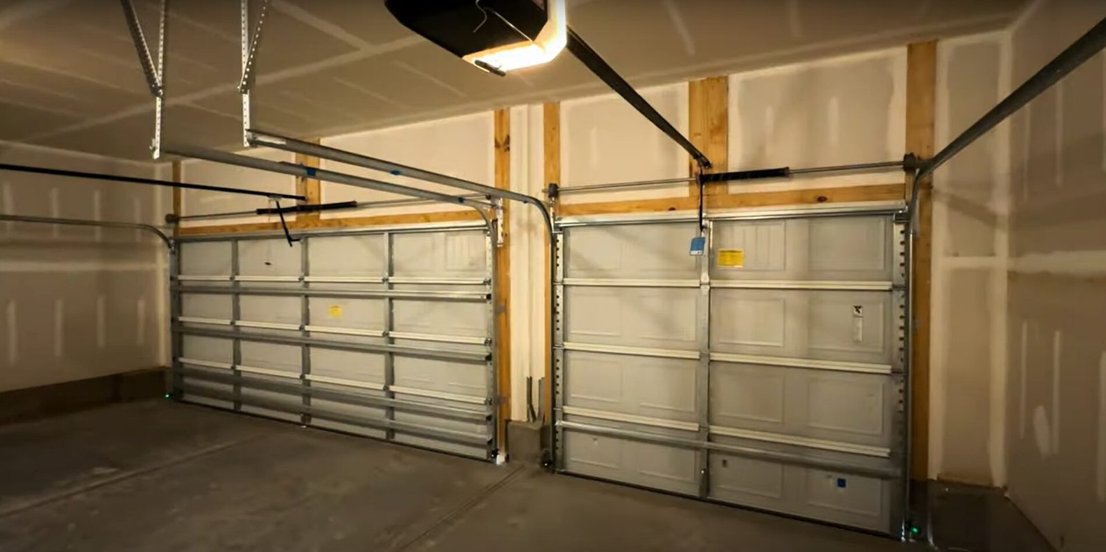 A skilled technician from Garage Door Repair Delaware, Ohio is performing maintenance on a residential garage door, showcasing the company's expertise in delivering reliable and efficient repair services.