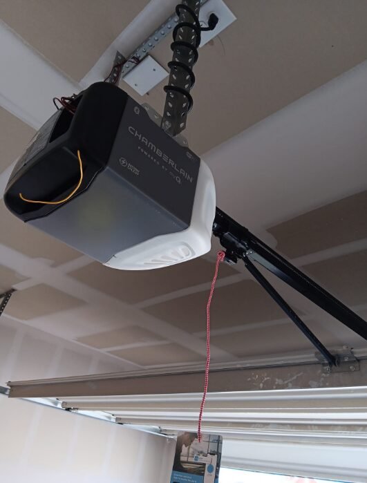 a technician fixing a garage door opener in Delaware, Ohio, highlighting expert garage door repair services.
