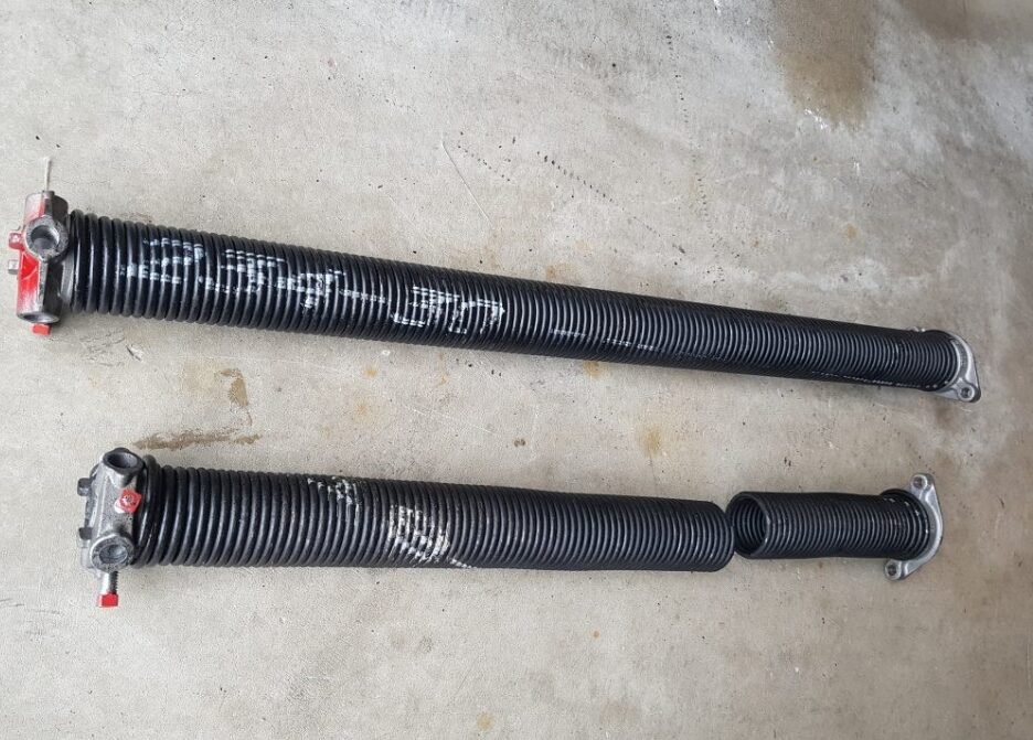 Close-up view of a technician performing garage door spring repair in Delaware, Ohio, showcasing the intricate process and expertise required for safe and efficient garage door maintenance.